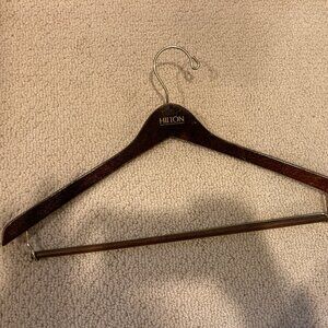 Vintage Hilton dark brown glossy wooden suit hanger.  some scratches.